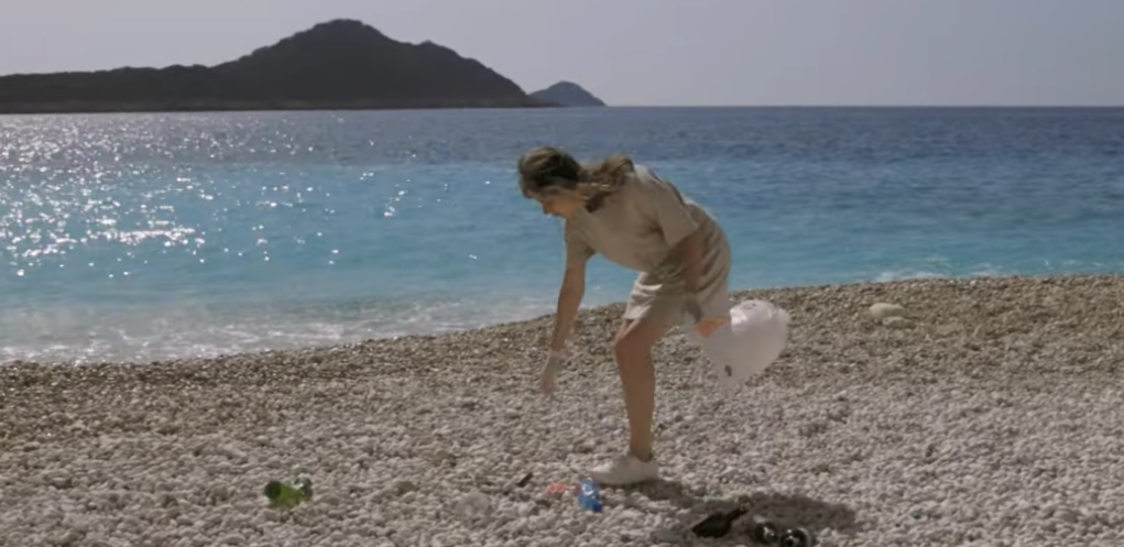 Beach cleanup by a woman tourist