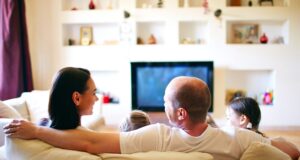 From Keywords to Conversations: How to Optimize Your Guesthouse for AI Assistants Family relaxin a hotel room with streaming enetertainment