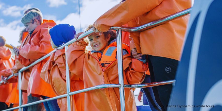 Adventure Tourism-How Hospitality Can Win Travellers with Scuffed Boots and Green Hearts 4 A row of professional-grade waterproof jackets and orange life jackets prepared for guests on a Marine Dynamics Travel boat for a whale watching tour.
