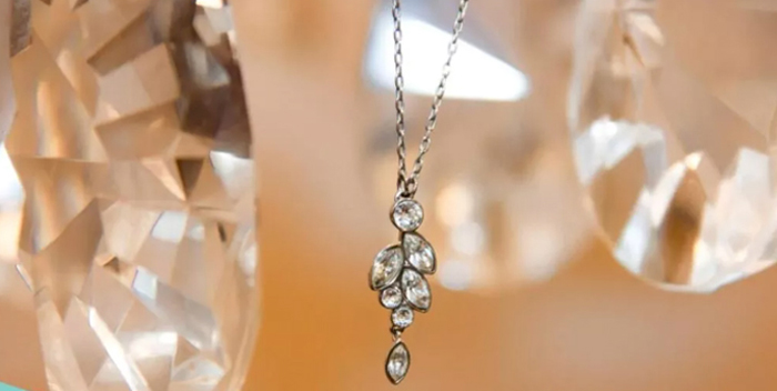 This conceptual image features industrial wrenches resting on a sleek computer keyboard, serving as a powerful visual for website optimization and technical maintenance. For a jewelry or apparel brand, this represents the "behind-the-scenes" work required to align a digital storefront with voice search algorithms.